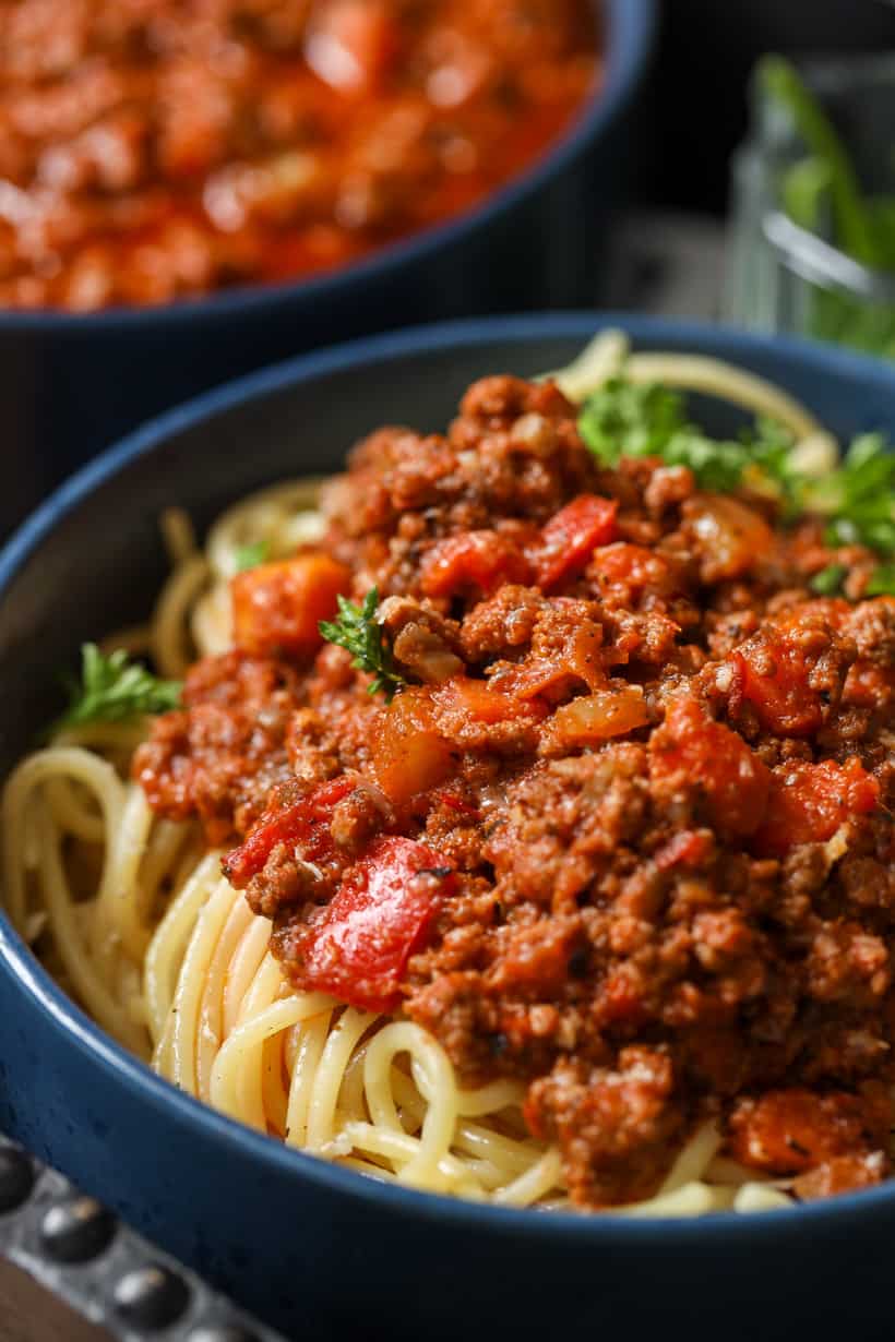 hearty, thick, beef bolognese recipe in blue bowl