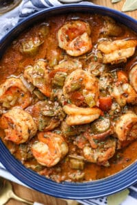 smothered okra, shrimp, and tomatoes in blue bowl