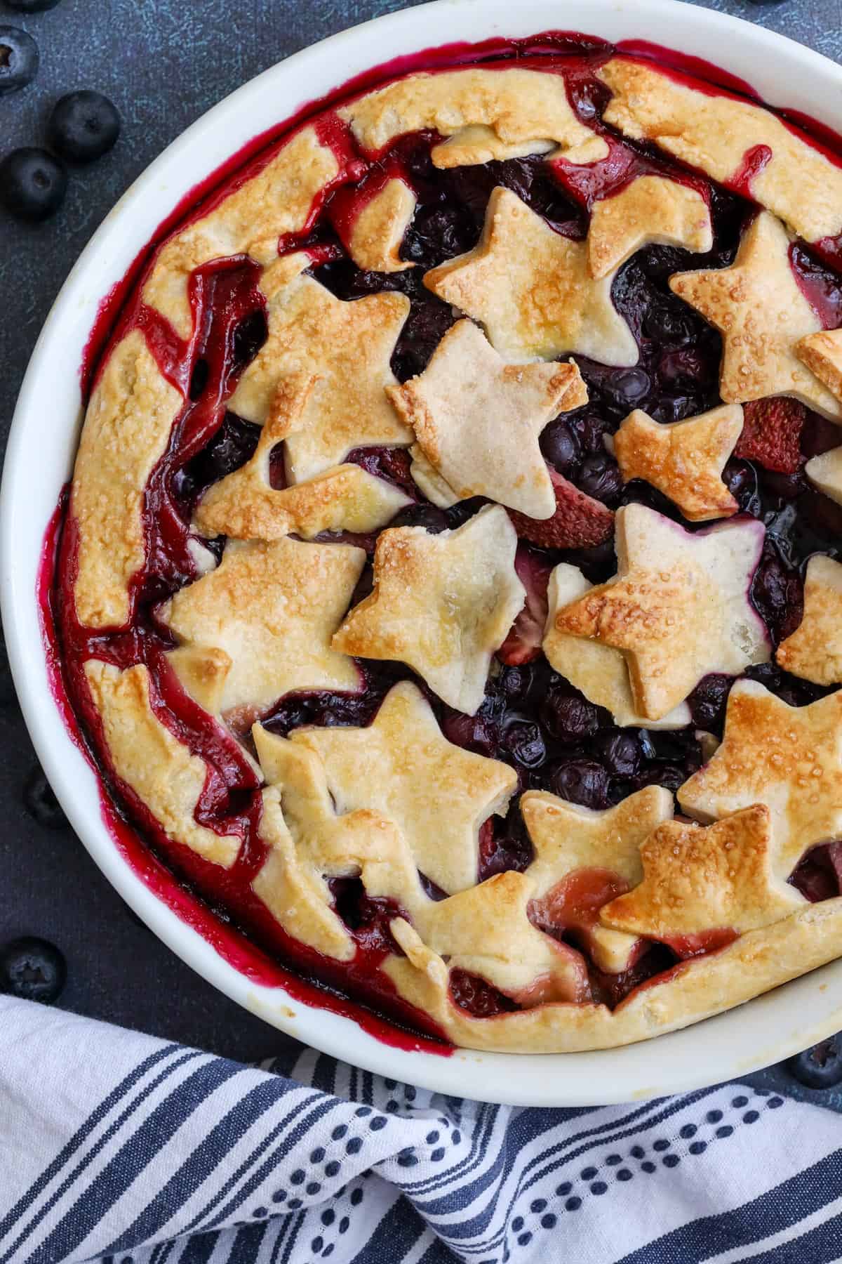 Baked blueberry strawberry pie in white pie dish