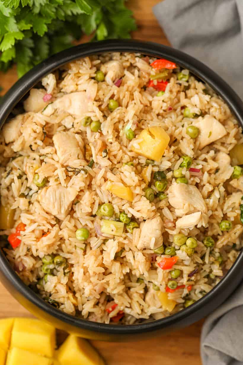 Mango Fried Rice in black bowl with herbs