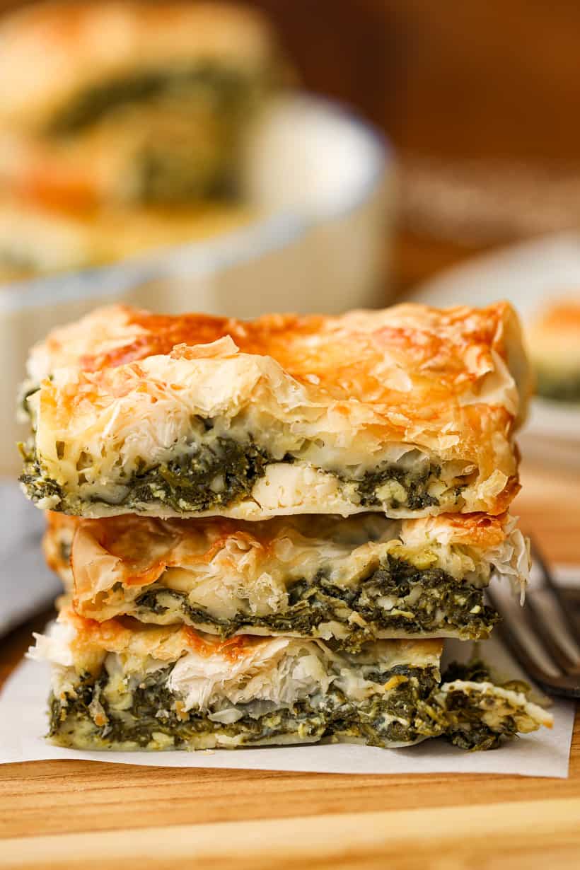 3 slices of spinach pie stacked on top of each other