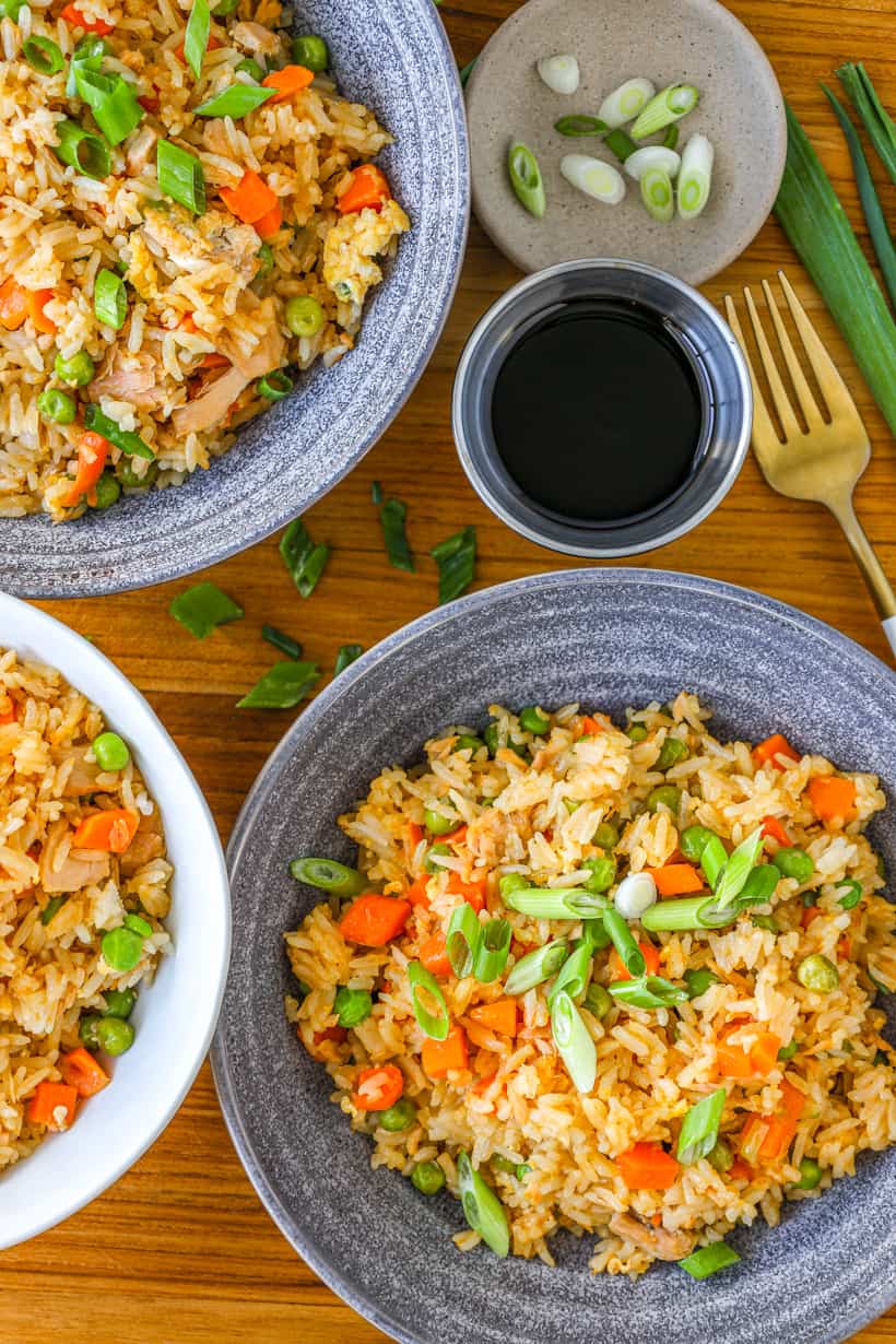 tuna fried rice with sliced green onions and soy sauce on the side