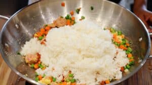 adding rice to vegetables