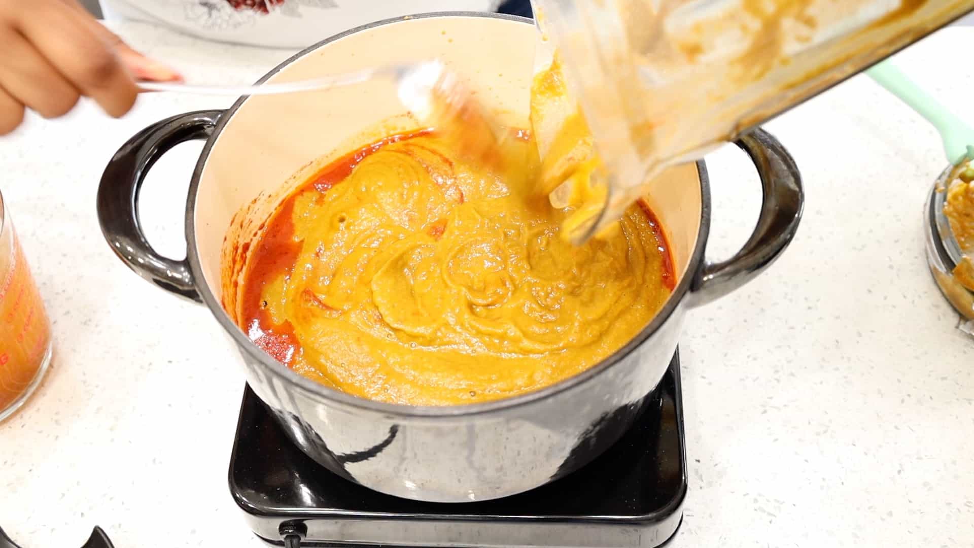 adding tomato mixture to the large pot