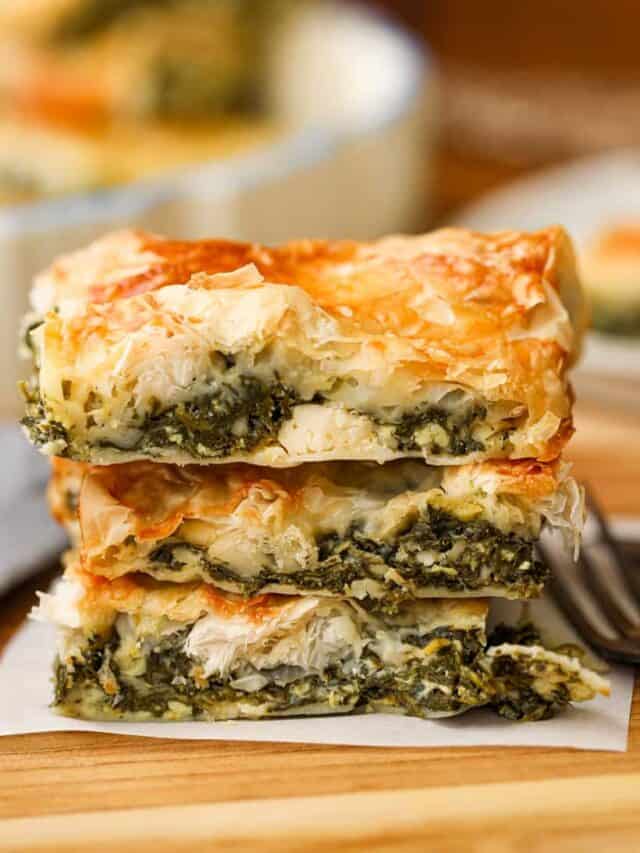 3 slices of spinach pie stacked on top of each other