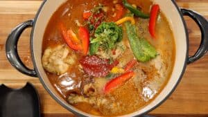 Herbs, tomato paste, and spice on top of chicken sauce