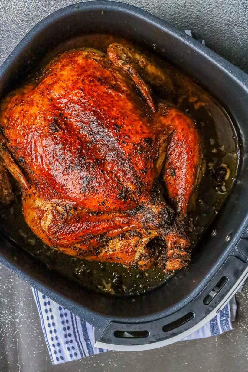 Air fryer whole chicken in the basket.