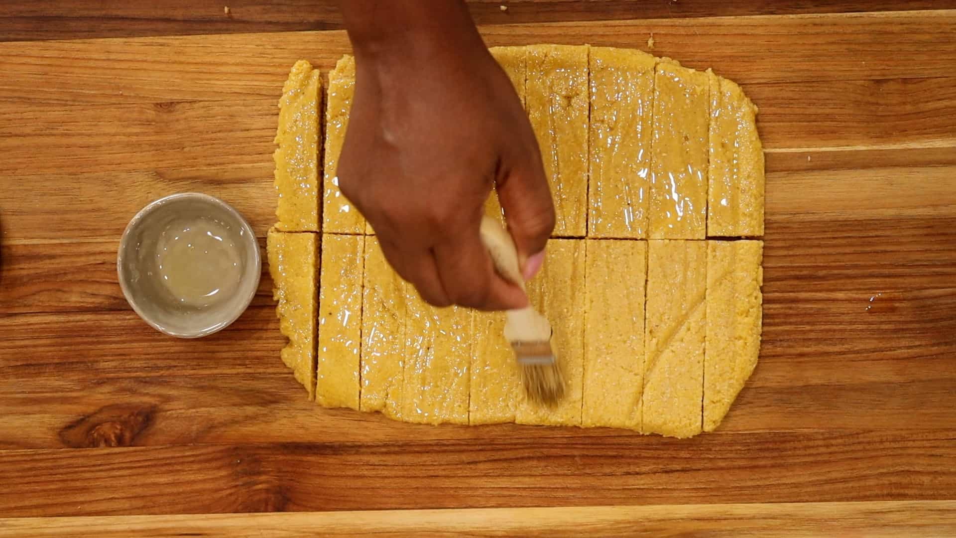 Brushing Polenta Fries with oil