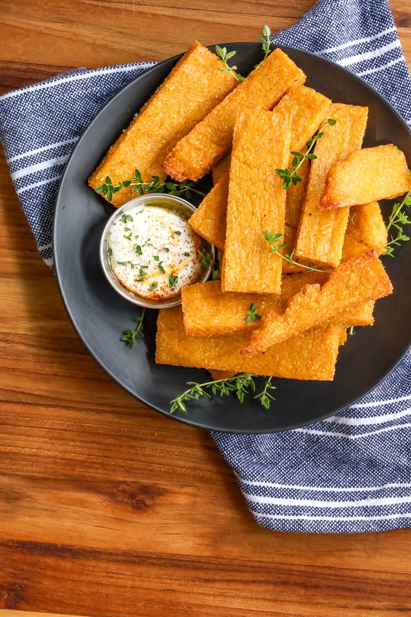 Polenta fries on black plate