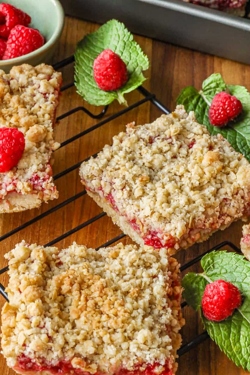 Raspberry Crumble Bars topped with raspberry and mint