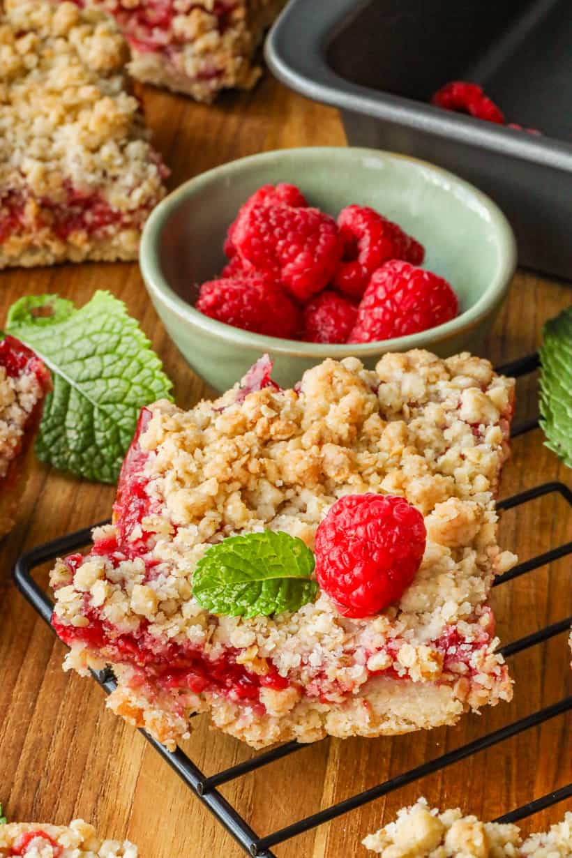 Raspberry Crumble Bars topped with raspberry and mint