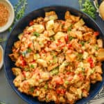 perfectly loaded roasted potato salad in blue bowl