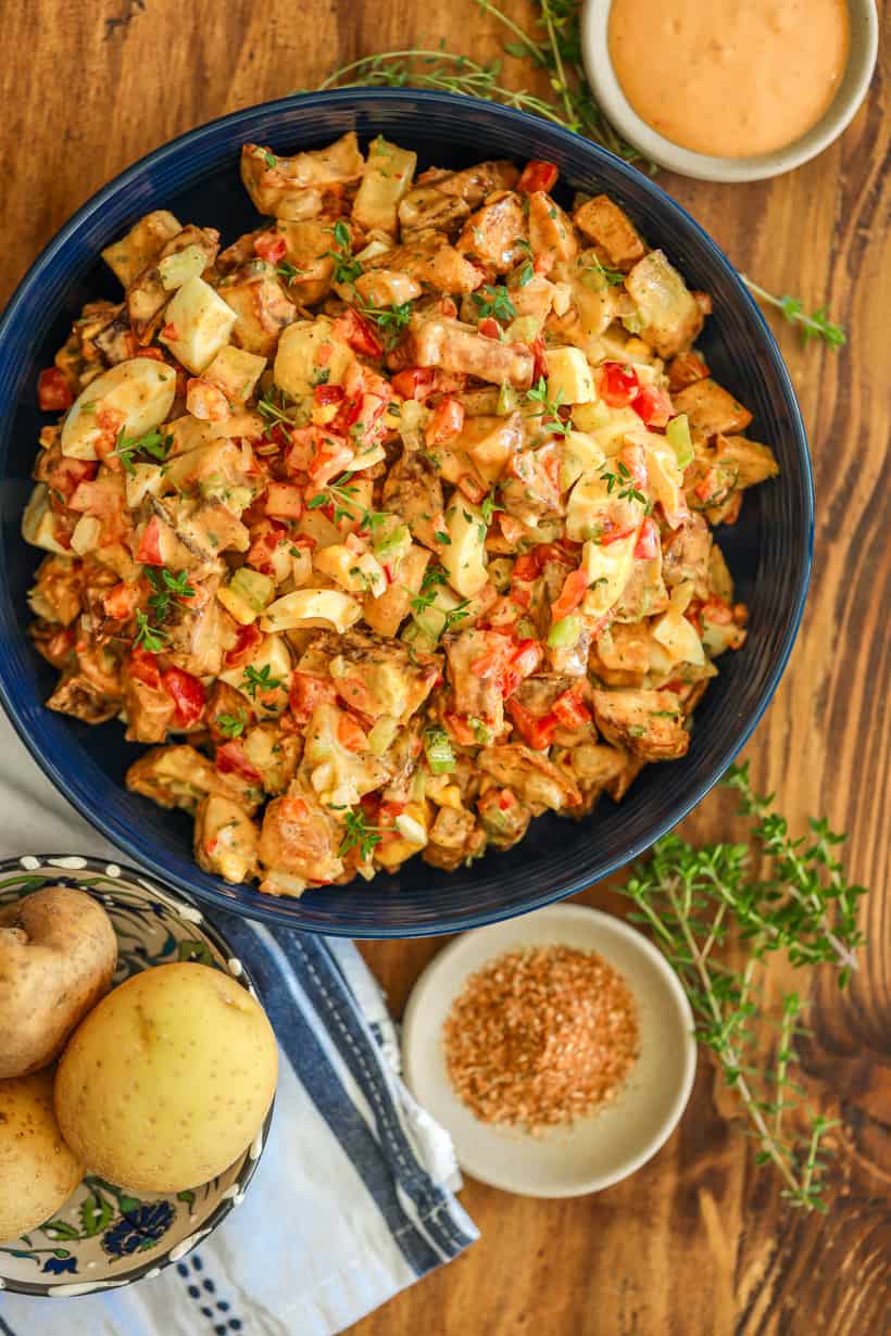 Roasted potato salad bowl on wooden board
