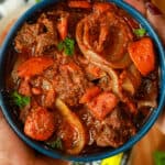 Hand holding Haitian Beef Stew / Sauce