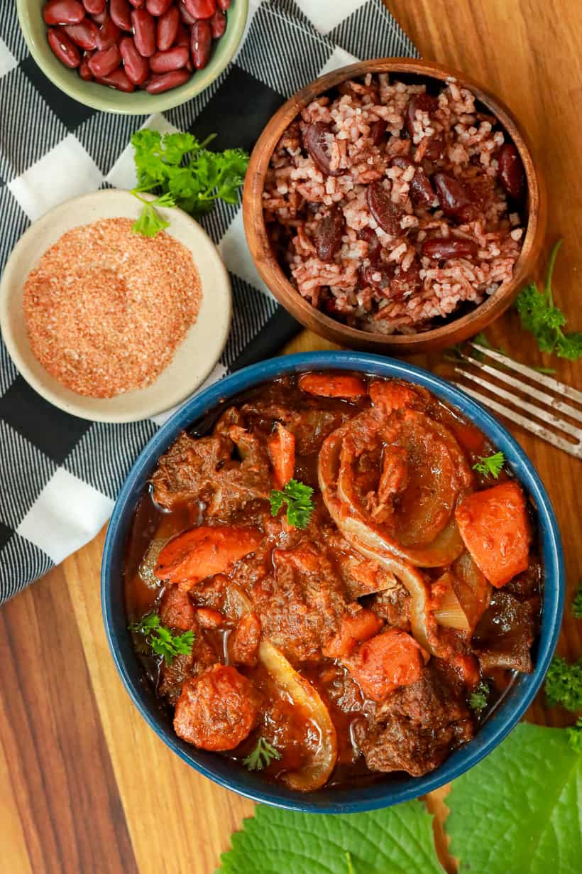Haitian short ribs stew in blue bowl with rice