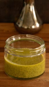 homemade pesto sauce in clear jar