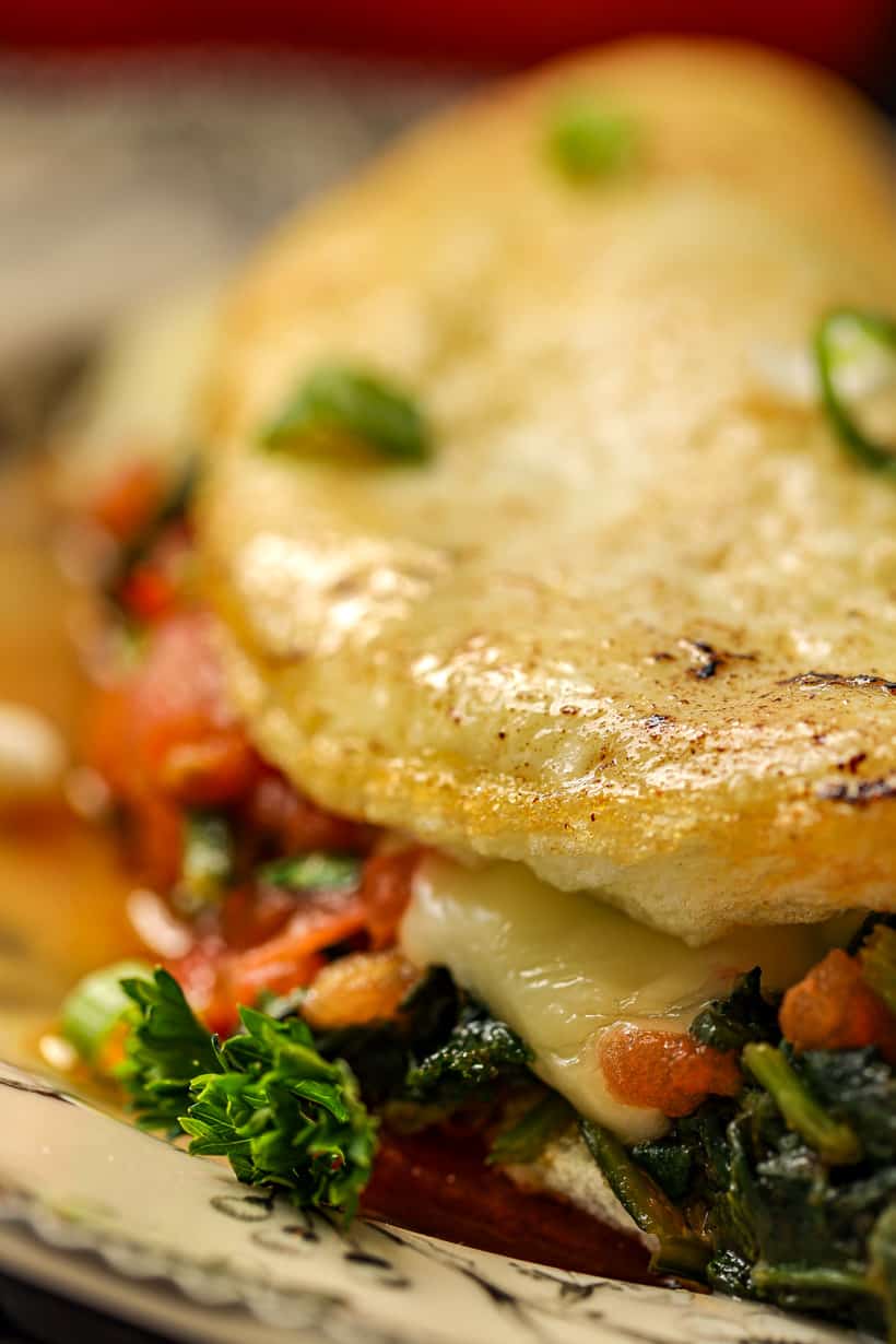 Delicious egg omelet that's prepared with tomatoes, parsley, parmesan cheese, and spinach.