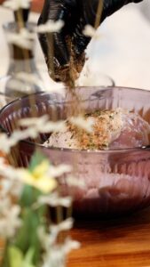 Applying spices to turkey breast