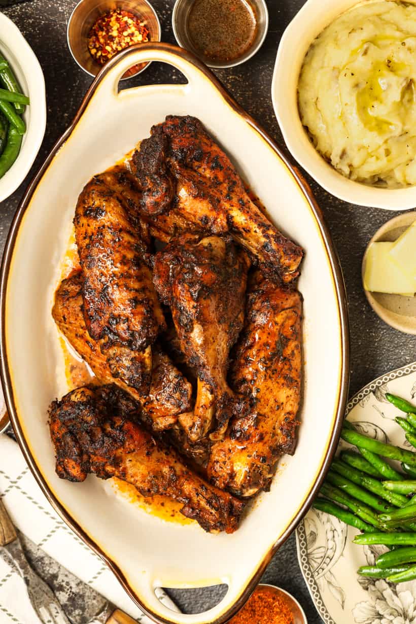 baked Turkey wings surrounded with mashed potatoes and green beans