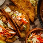 Haitian chicken tacos topped with pikliz