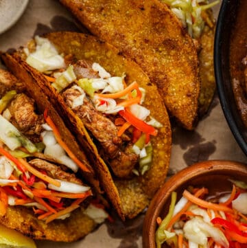 Haitian chicken tacos topped with pikliz
