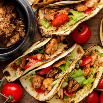 Salmon tacos on a bowl and flat on a board