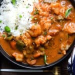 shrimp etouffee with rice in a black bowl