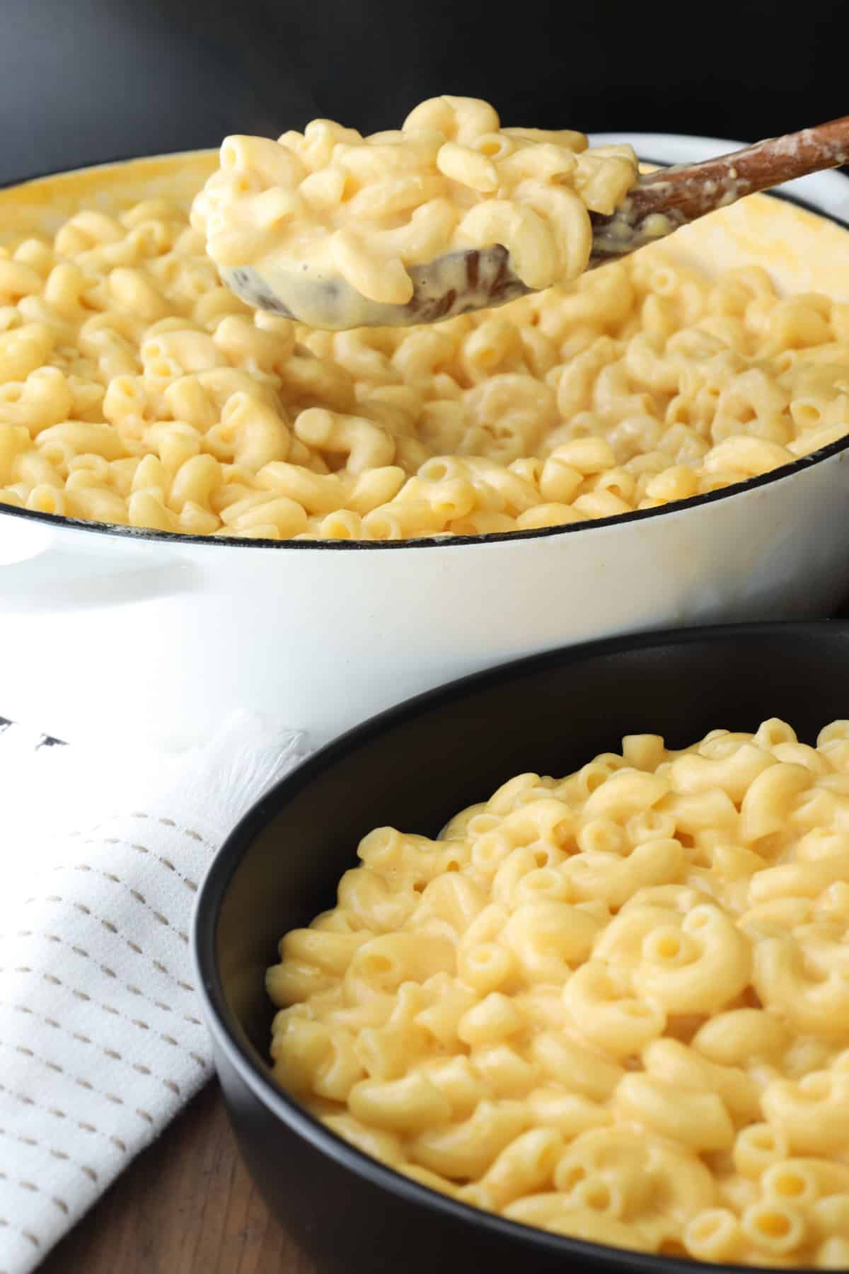 wooden spoon lifting Mac and cheese