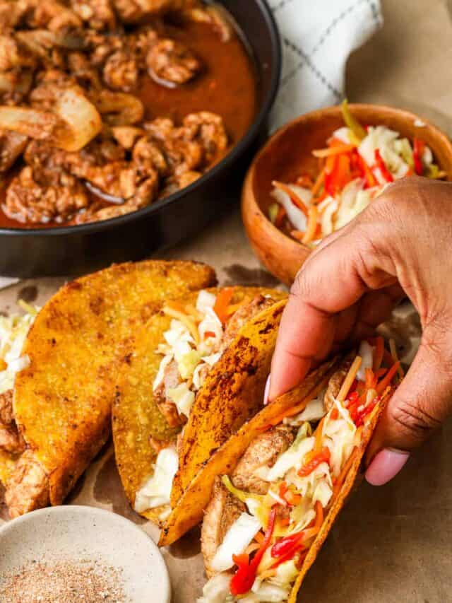 Hand holding Haitian Chicken Tacos