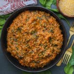 Spinach with polenta (Haitian mais moulin ak zepina) in black bow.