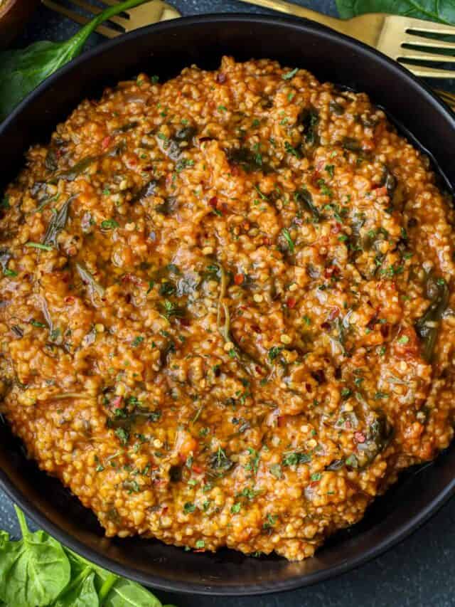 Spinach with polenta (Haitian mais moulin ak zepina) in black bow.