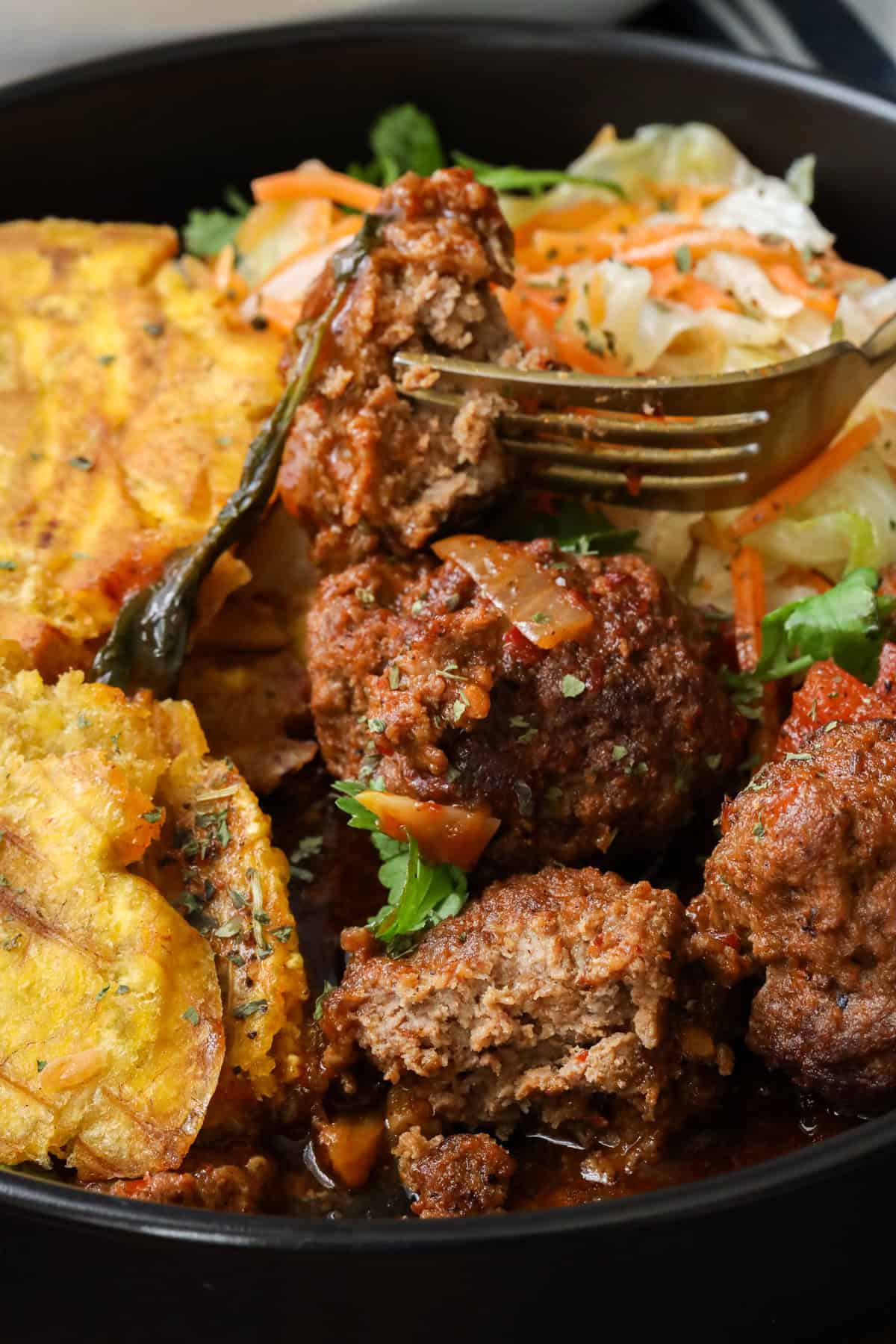 Harissa meatballs paired with plantains and cabbage.