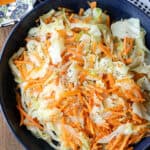 Steamed cabbage Jamaican Style prepared with carrots in blue plate