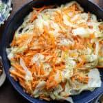 Steamed cabbage Jamaican Style prepared with carrots in blue plate