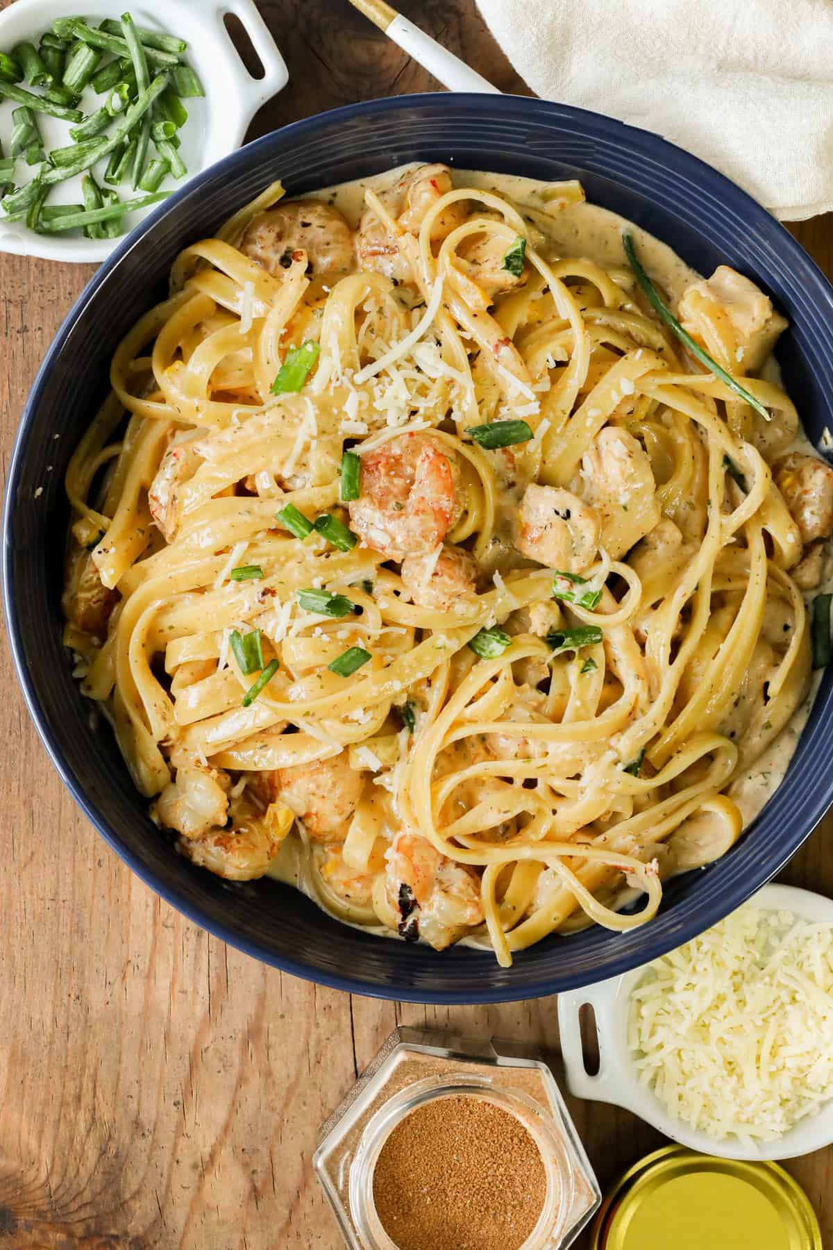 Cajun chicken and shrimp pasta in blue bowl