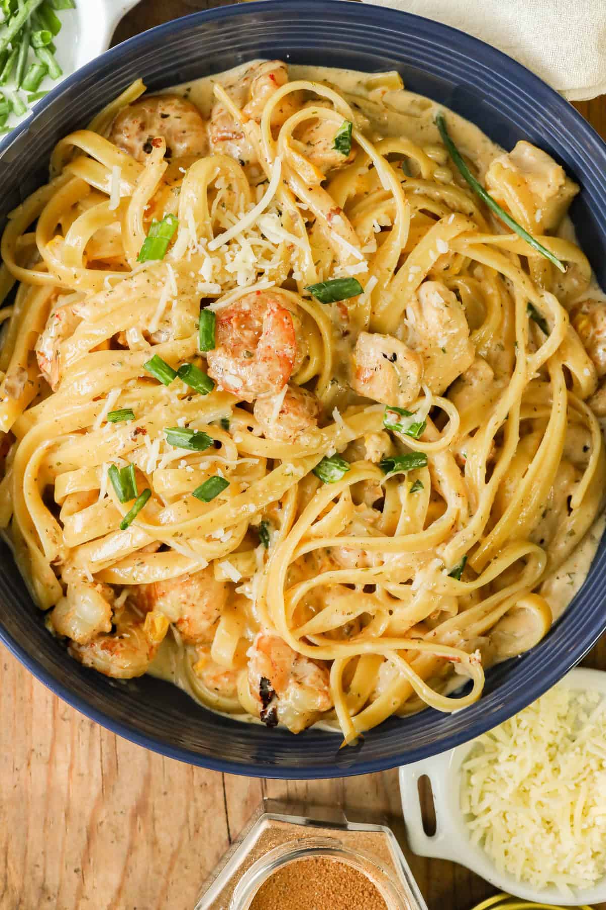 Cajun chicken and shrimp pasta in blue bowl