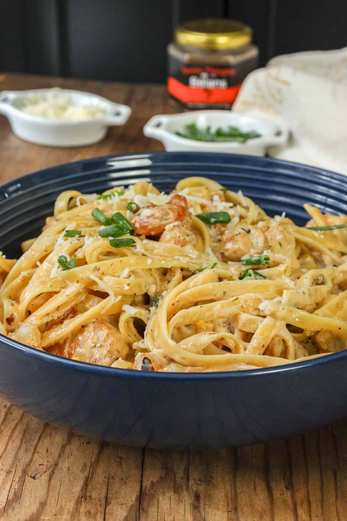 Cajun chicken and shrimp pasta in blue bowl