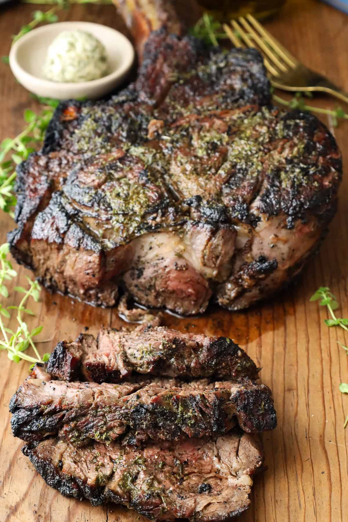 Well done Grilled Cowboy Steak on wooden board
