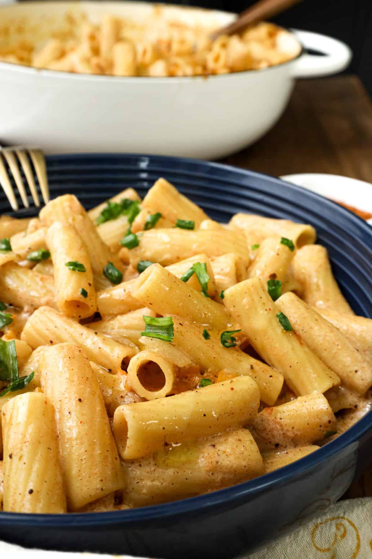 Rasta Pasta in blue bowl with fork on the side.