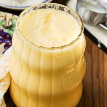 tropical milkshake in clear glass with straw