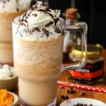 pumpkin spice Frappuccino topped with whipped cream, chocolate chips and chocolate syrup.