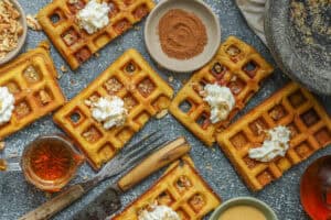 Pumpkin waffles topped with nuts and whipped cream
