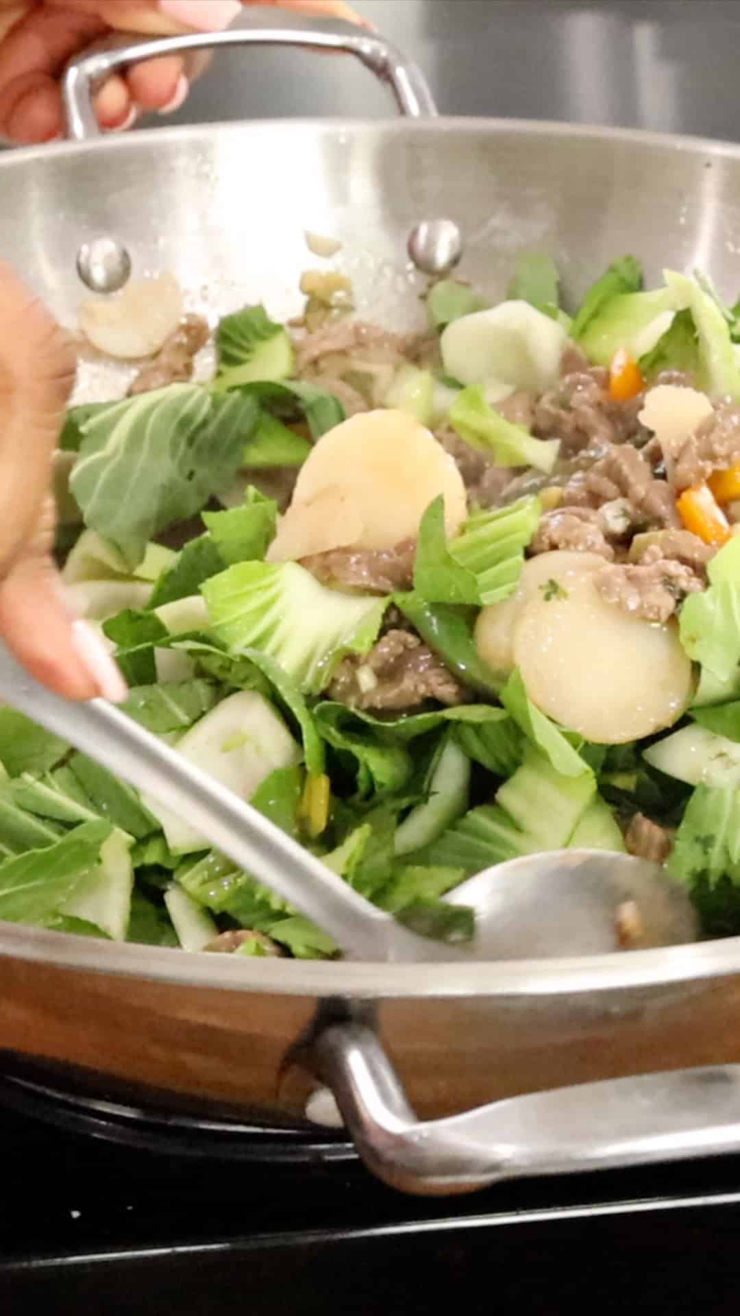 Adding bok choy to beef