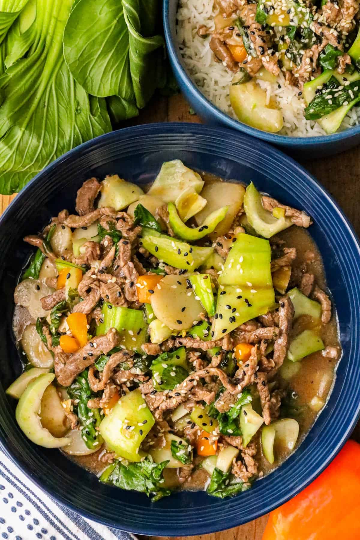Beef Bok Choy recipe in blue bowl, and layer over a bed of white rice.