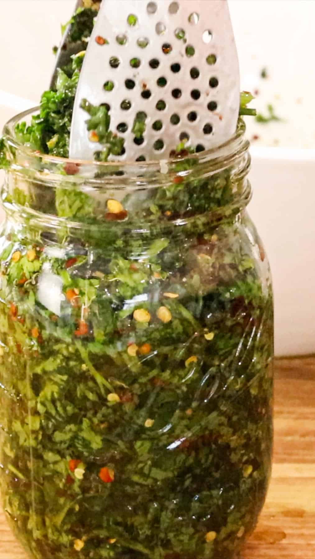 Transferring parsley to mason jar.