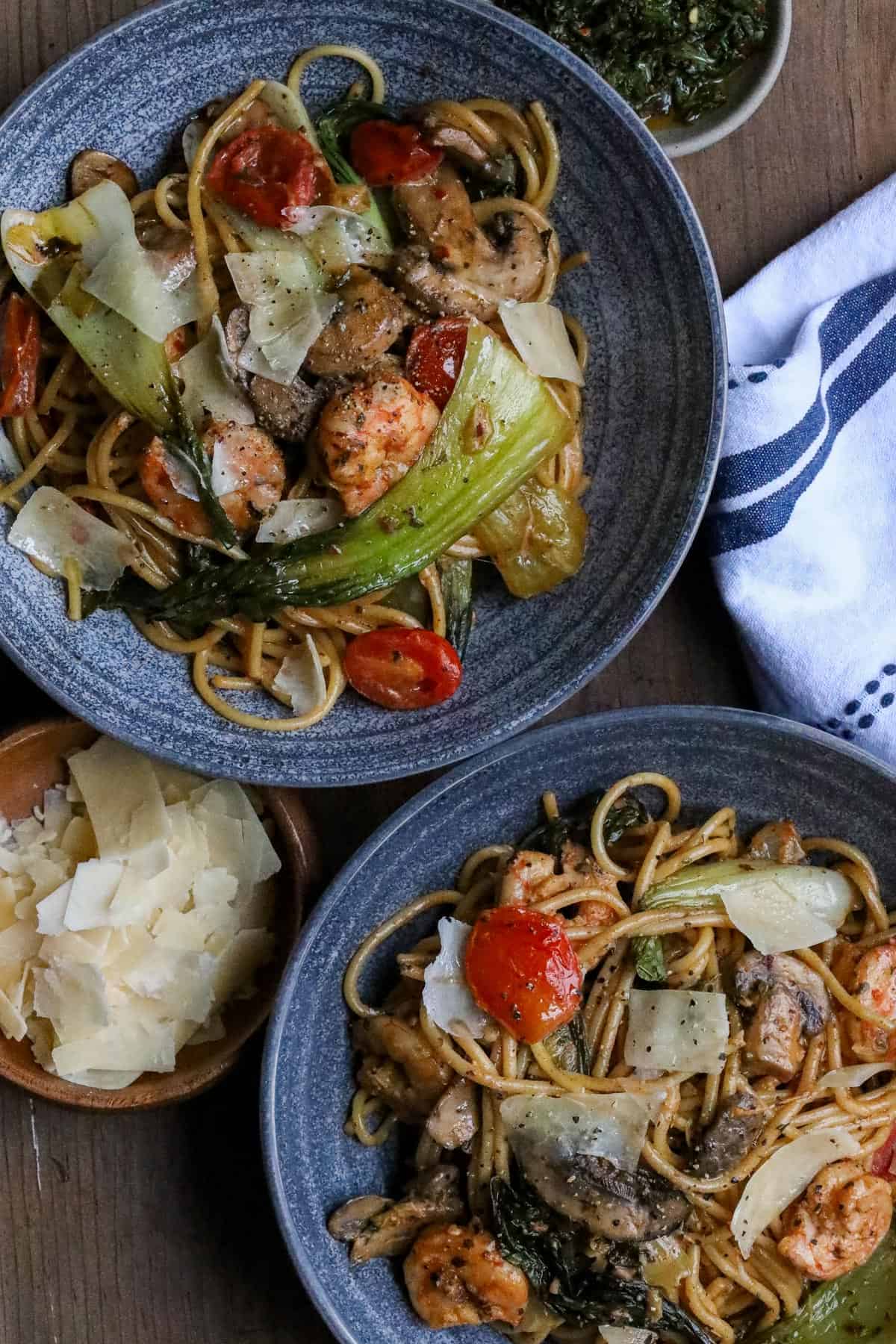 bok choy with shrimp, tomatoes, and mushroom in gray bowl.