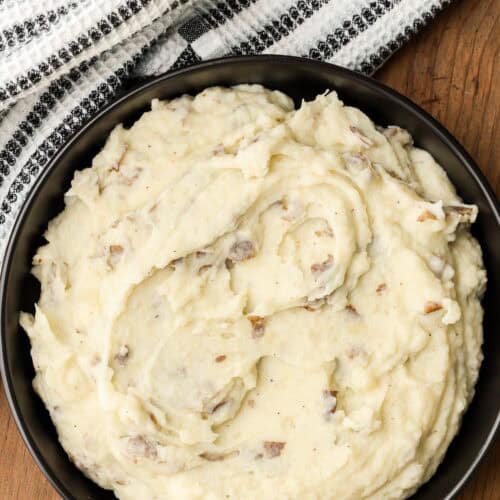 Skin on mashed potatoes in black bowl