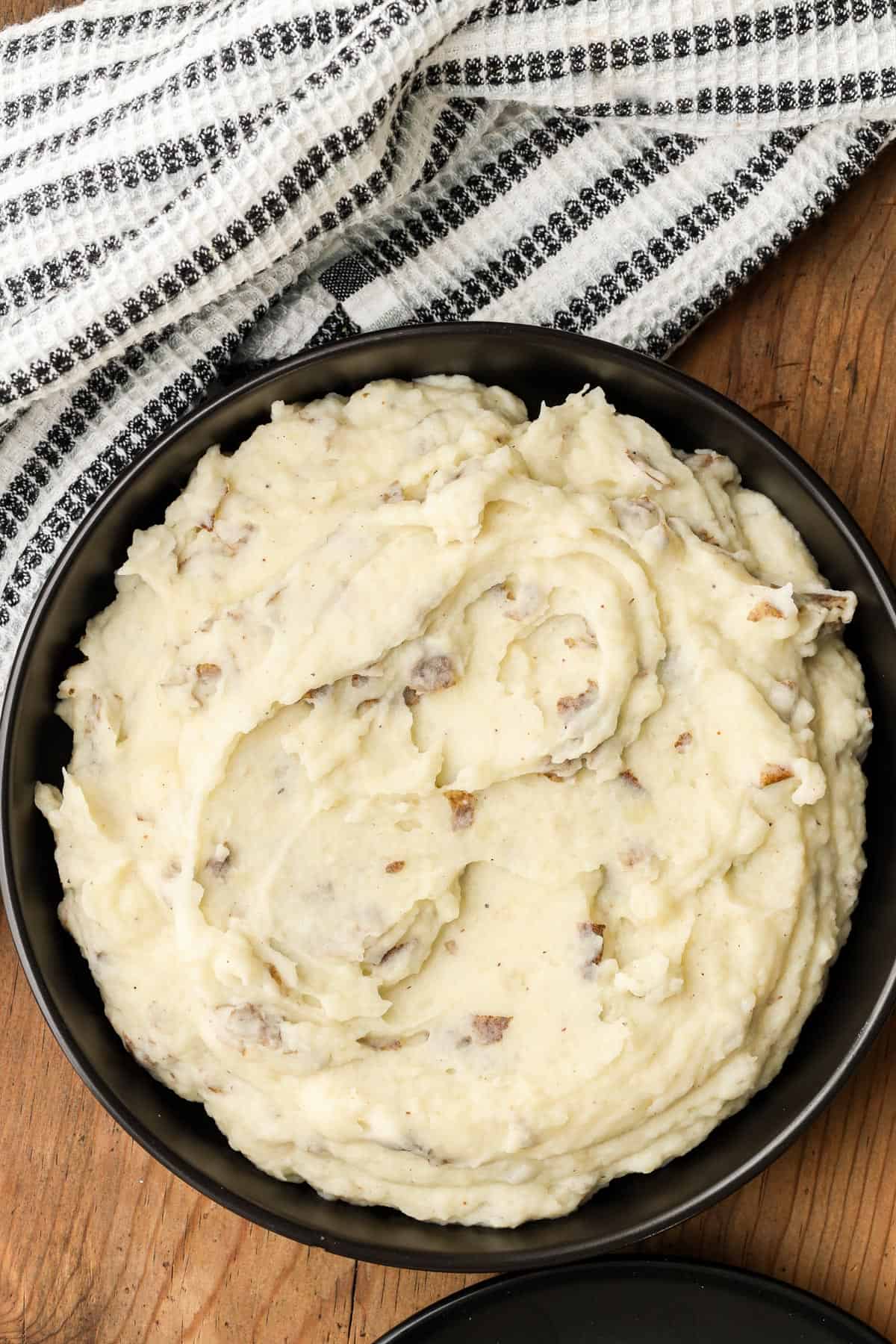 Skin on mashed potatoes in black bowl