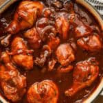Oven baked bbq chicken drumsticks with mashed potatoes and asparagus on wooden board