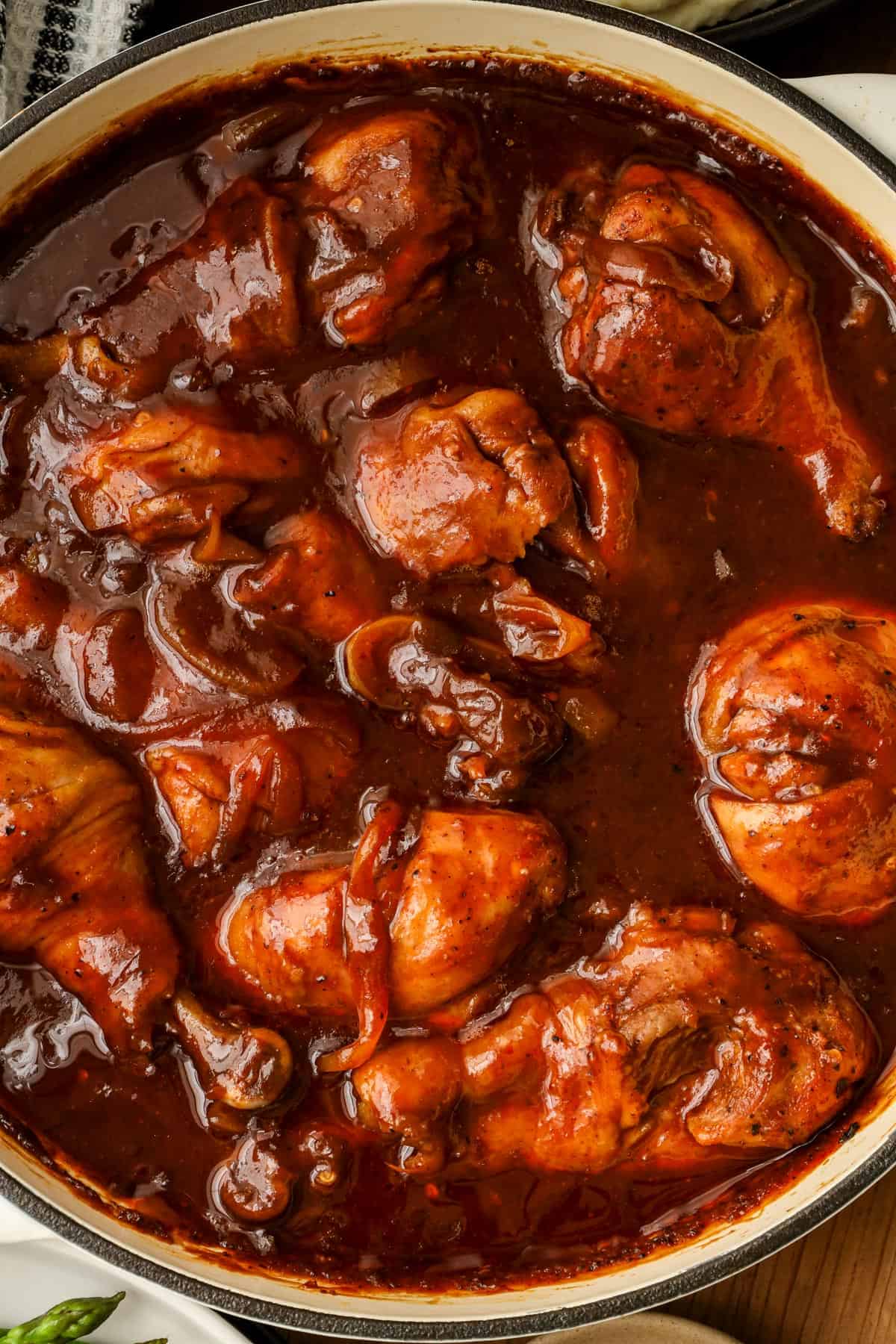 Oven baked bbq chicken drumsticks on wooden board